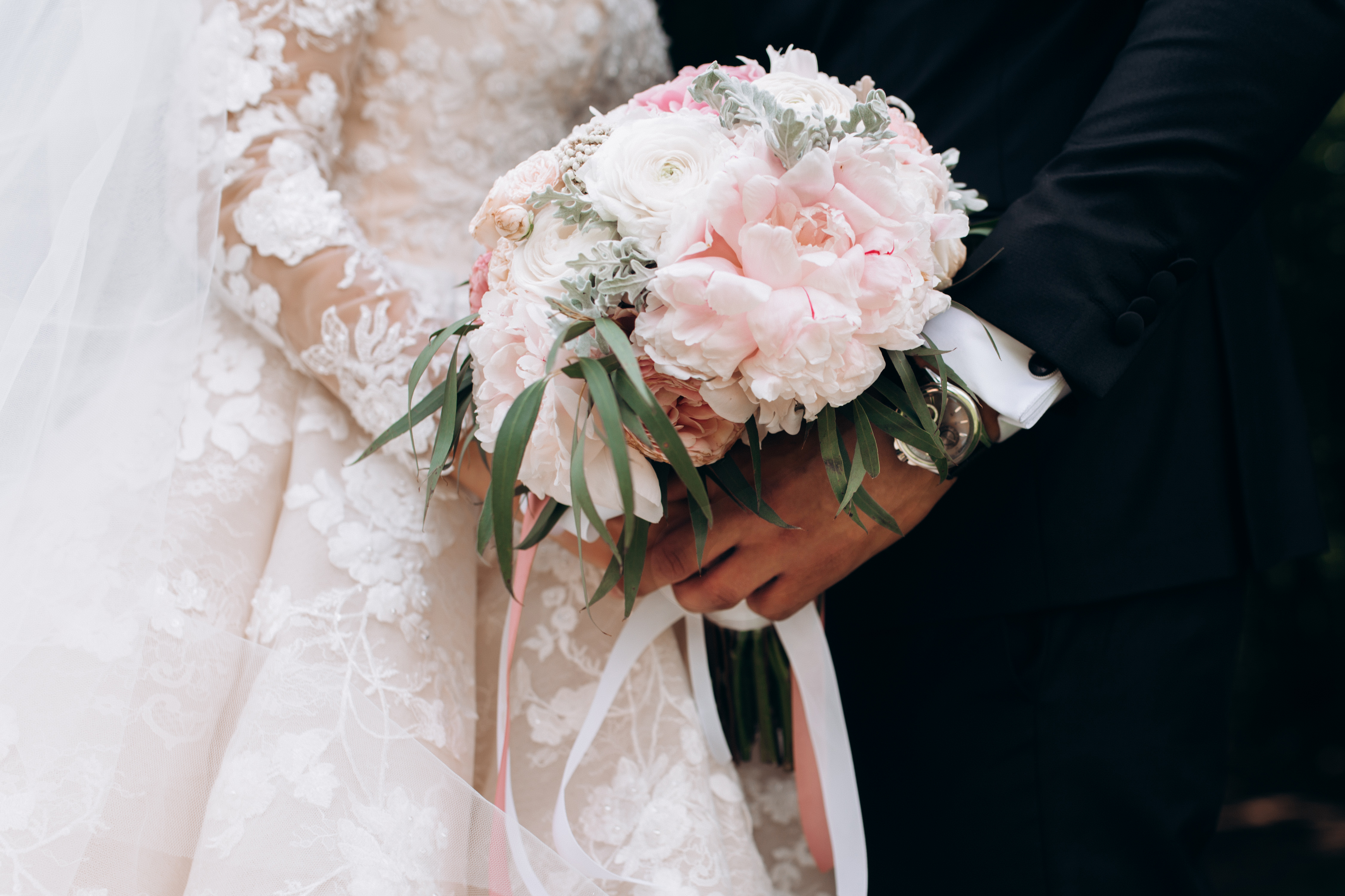 Mariés tenant un bouquet rose